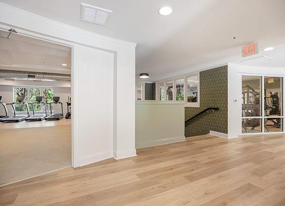 A room with a wooden floor and a green wall.
