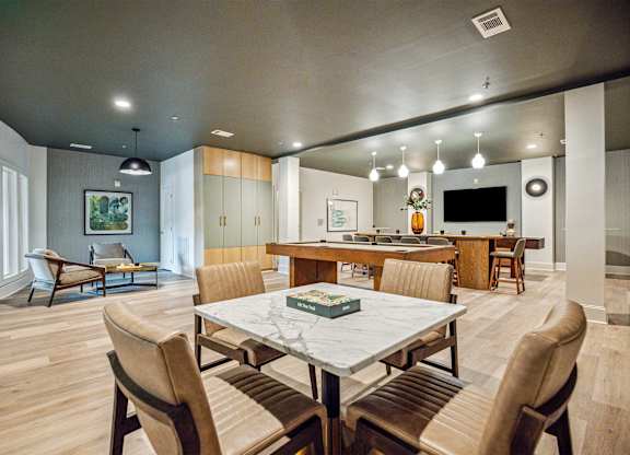 A modern dining room with a large table and chairs.