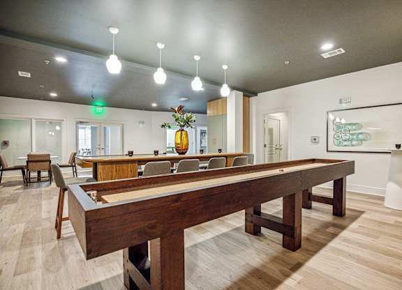 A room with a long table and chairs.