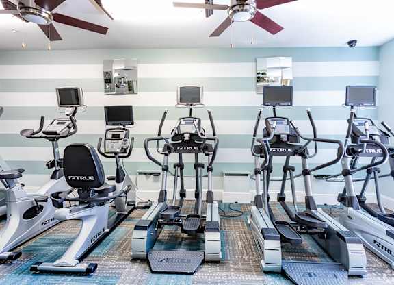 A gym with treadmills and exercise bikes.