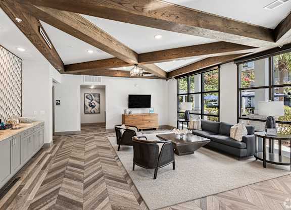 A modern living room with a wooden floor and ceiling.