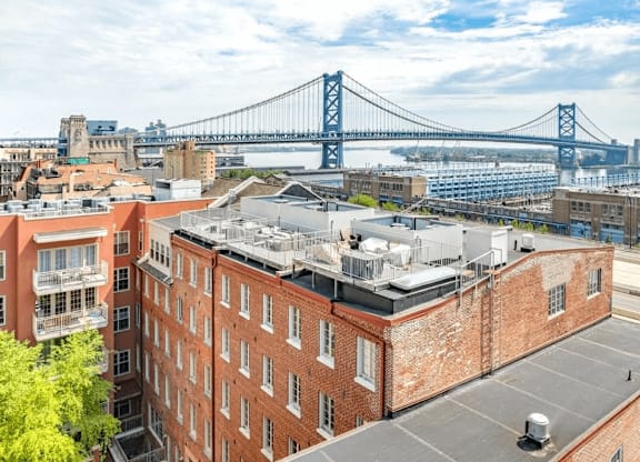 A view of a cityscape with a bridge in the background.