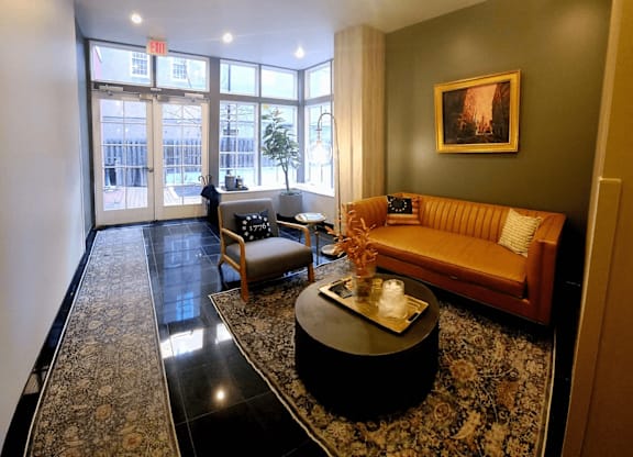 A living room with a couch, chair, and coffee table.