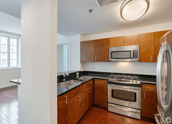 A kitchen with wooden cabinets and stainless steel appliances.