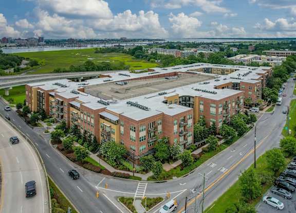 A large building complex with a parking lot in front.