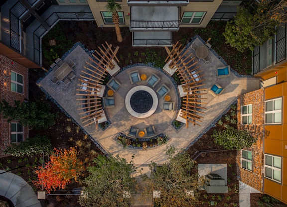 A courtyard surrounded by buildings with a circular design in the middle.