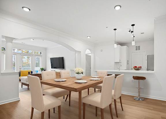 A dining room with a wooden table and chairs.