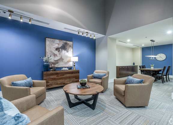 A living room with blue walls and furniture.
