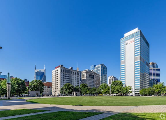 A cityscape with a tall building in the center.
