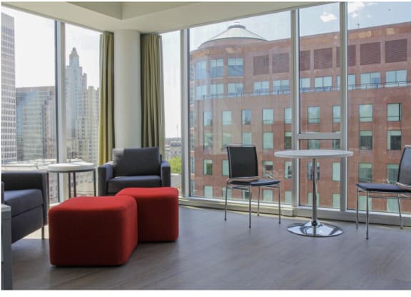 a living room with chairs and a table and a large window