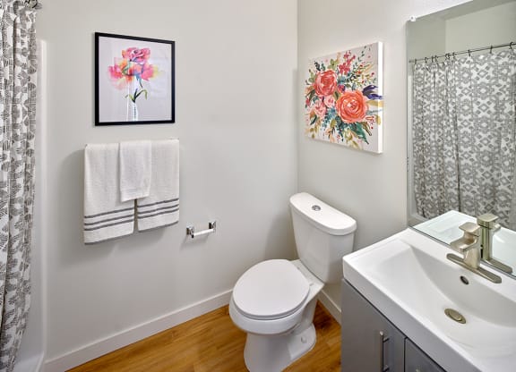 a bathroom with a toilet and a sink and a shower at Enve, Seattle, 98102