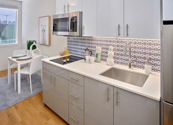 a kitchen with stainless steel appliances and a sink and a microwave at Enve, Seattle, WA