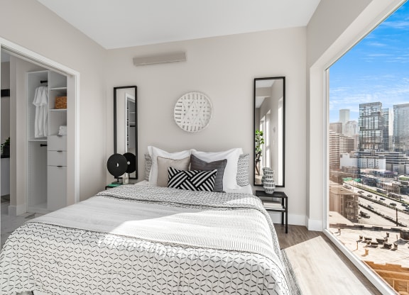a bedroom with a bed and a large window  at Oslo, Seattle, WA, 98102
