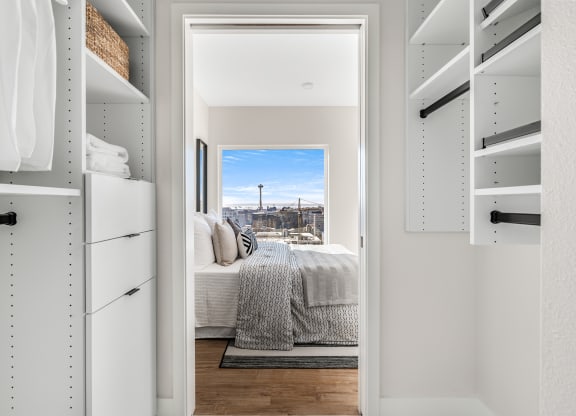 a walk in closet with a bed and a city view  at Oslo, Seattle, Washington