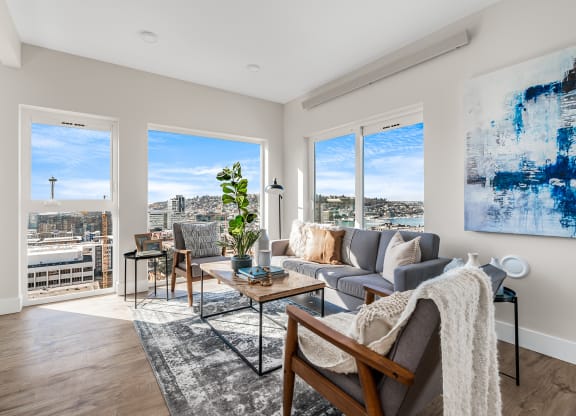 an open living room with a view of the city and a couch and chairs  at Oslo, Seattle, Washington