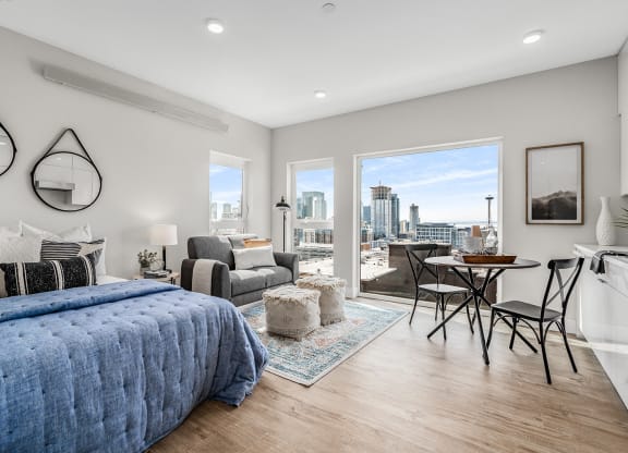 a bedroom with a large bed and a view of the city  at Oslo, Seattle, WA, 98102