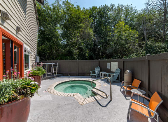 a backyard with a pool and patio with chairs and a table at Quartz Creek, Washington, 98043
