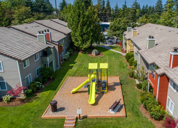 an aerial view of a yellow swing set in the backyard of a house at Quartz Creek, Washington