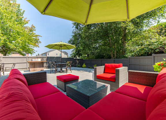 a patio with couches and chairs and a table at Quartz Creek, Mountlake Terrace