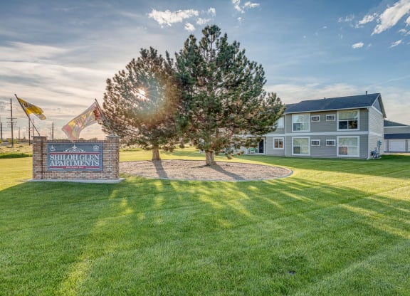 the yard of a house with a tree and a sign at Shiloh Glen, Billings, 59102