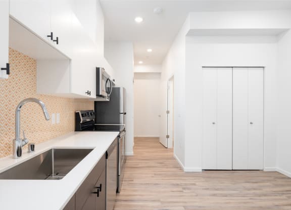 a renovated kitchen with white cabinets and a sink at The Loop at Green Lake, Seattle, WA, 98115