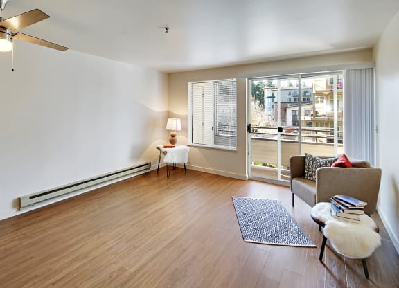 a living room with a couch and a chair and a window  at Townside Flats, Redmond, WA