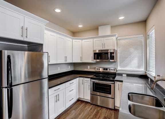 a kitchen with white cabinets and stainless steel appliances at Woodcreek, Poulsbo, 98370