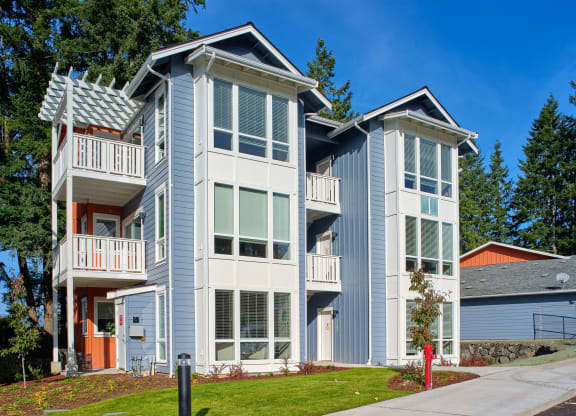 a blue and white house with a sidewalk in front of it at Woodcreek, Poulsbo, 98370