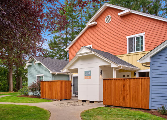 a group of houses with a sidewalk and a fence at Woodcreek, Poulsbo, 98370