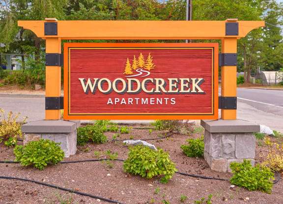 a sign for wood creek apartments on the side of the road at Woodcreek, Poulsbo, WA