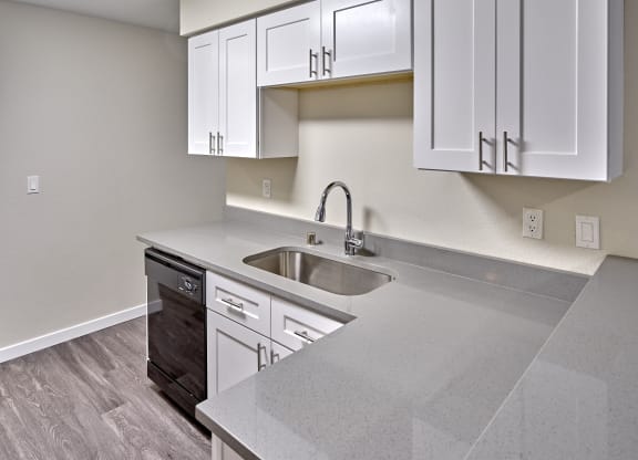 Kitchen with appliances and cabinets at Arterra Apartments, Kent, WA, 98030