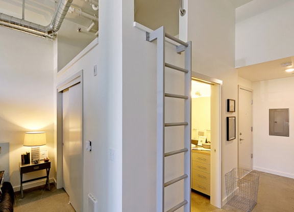 Loft apartment with vaulted ceilings. Staged bedroom on the left and a hallway to the kitchen and bathroom on the right.at 19th & Mercer, Washington, 98112