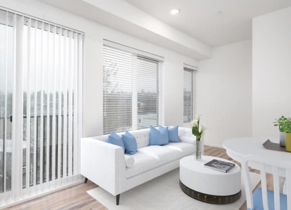 a living room with a white couch and a table
