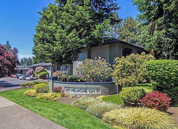 A sign that says Melrose Court in front of a building.