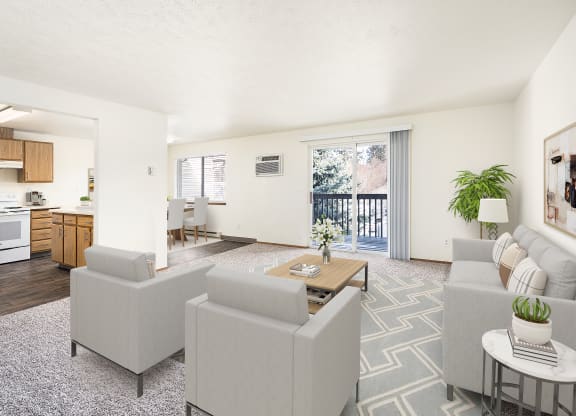 Spacious living room with glass sliding doors to private covered balcony. Living room staged with a couch, 2 chairs, and a coffee table. at Clearwater, Post Falls, ID 83854