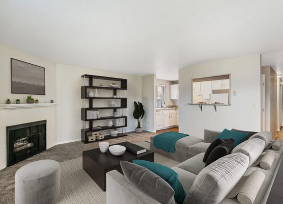 Carpeted living room, gas fireplace, and mantle on the left, with door and pass-through to kitchen area at Capitol Crossing, Olympia, WA