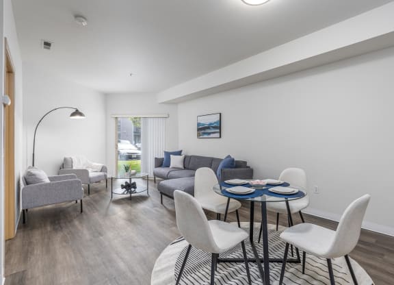 a living room with a couch and a table and chairs  at Shoreline Village, Richland, WA, 99352