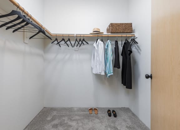 a walk in closet with a clothes rack and shoes on the floor  at Shoreline Village, Richland, WA, 99352