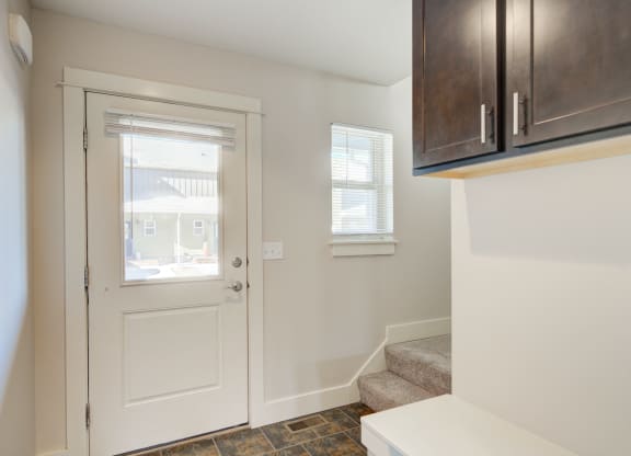 a entryway with a white door and a stairwell with a window at Copper Pines, Bozeman, MT, 59718