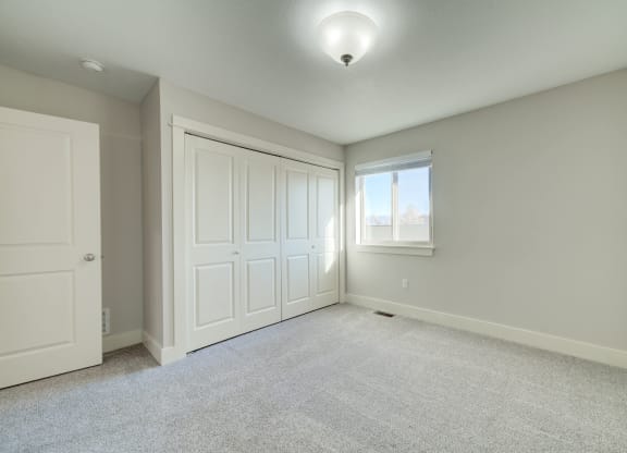 an empty room with two closets and a window at Copper Pines, Bozeman, MT, 59718