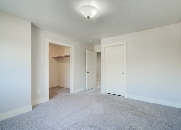 an empty living room with white walls and white doorways at Copper Pines, Bozeman, MT