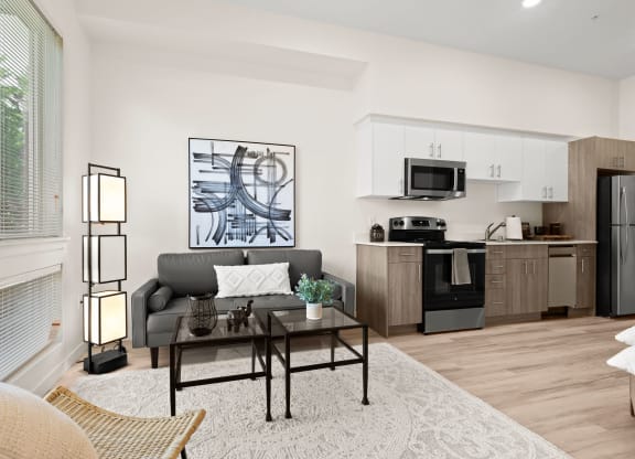a living room with a couch and a table at The Duo, University Place, WA
