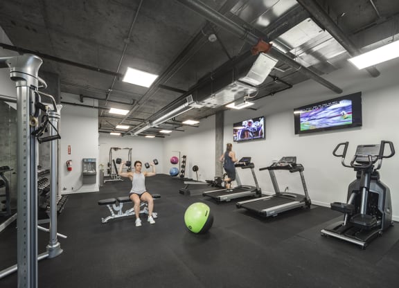 Gym with treadmills, an elliptical, weight machines, free weights, benches, an exercise ball and tvs at 6 Wood Flats, Lacey, WA