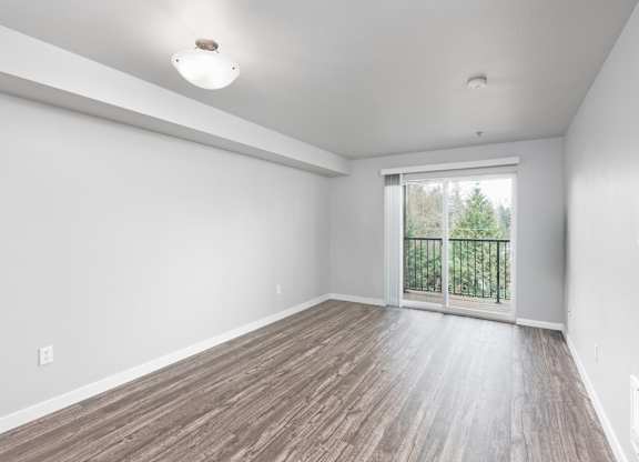 Large living room with sliding glass door in a 728 square foot 1 bedroom apartment at 6Wood Flats Apartments in Lacey WA