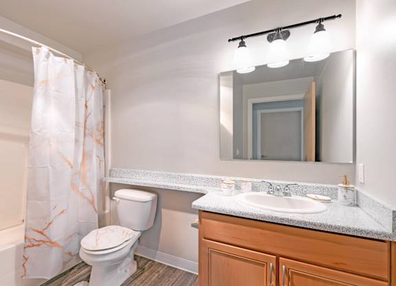 Spacious bathroom with oversized vanity and shower tub combination in a 728 square foot apartment at 6Wood Flats Lacey