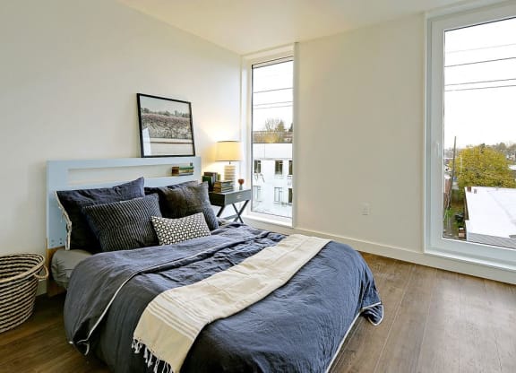 Large bedroom with 2 floor to ceiling windows. Bedroom can fit a queen or king sized bed.at 19th & Mercer, Seattle