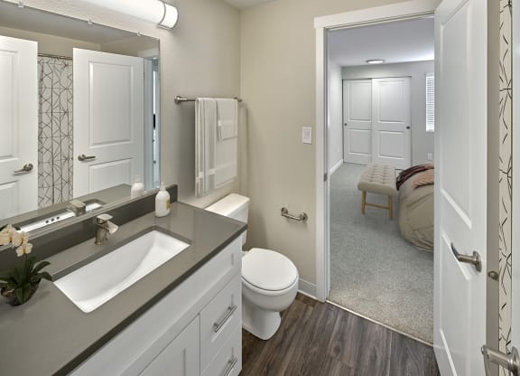 Ensuite bathroom with hard wood style flooring, toilet and vanity sinkat Edmonds Gateway, Bremerton.