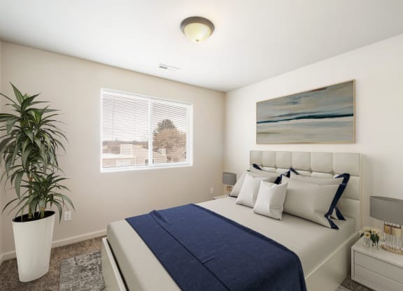 A furnished bedroom with a large window, gray carpets, and overhead lighting. Stayed with queen-size bed, side tables, and a house plant. at Pine Tree Park, Kennewick, 99337