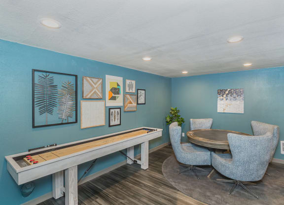 Lounge area with hardwood floors, shuffle board, and game table and chairs.at Cedarwood, Renton Washington