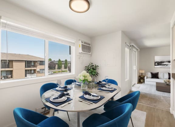 a dining area with a glass table and blue chairs and a large window with a view of  at Brix, Washington, 99362